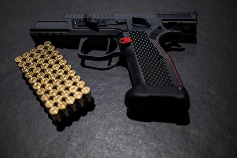 Modern Elegant Sport Handgun with Gas Pedal and Skirt and Bullet on Grey Background in Switzerland