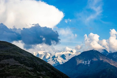 Beautiful Aerial View over Swiss Alps with Glacier in a Sunny Day and Clouds over St Moritz,