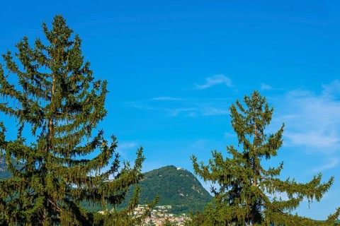 Mountain Bre and Village on Mountain Peak in the Swiss Alps and Blue Sky in a Sunny Summer Day in