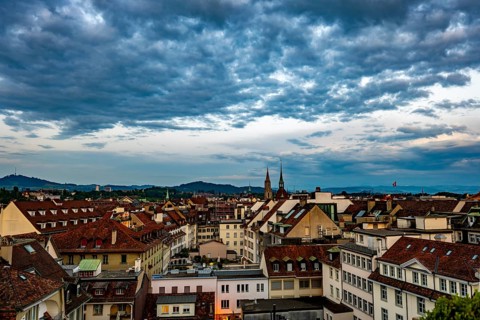 Panoramic Beautiful Cityscape and Cathedral Tower in Sunset with Cloudscape in City of Bern, Canton