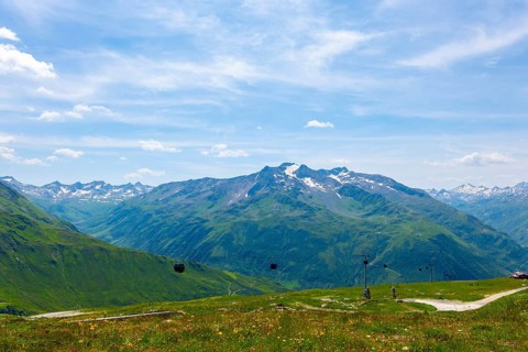 Beautiful Panoramic View over Mountain Peak with Snow in the Swiss Alps From Overhead Cable Car in