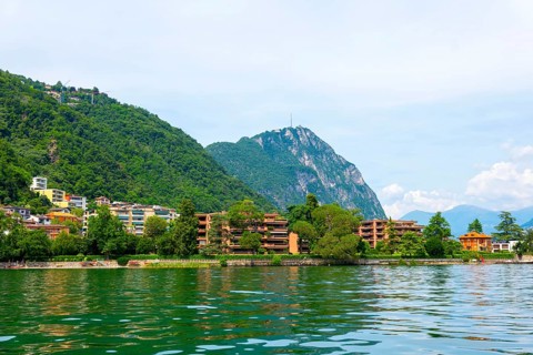 Elegant Building on the Mountain Side in a Sunny Summer Day on the Waterfront to Lake Lugano in