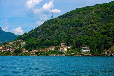 House and Mountain Range in a Sunny Summer Day on the Waterfront to Lake Lugano in Figino, Lugano,