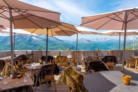 View From a Restaurant Terrace with Parasol and with Mountain Peak in the Swiss Alps and Sky in a