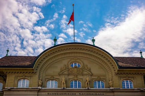 Beautiful Swiss National Bank with Flag in a sunny Day with Blue Sky and Clouds in City of Bern,