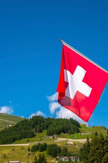 Beautiful Swiss Flag Against Mountain in the Swiss Alps in a Sunny Summer Day in Andermatt, Uri,