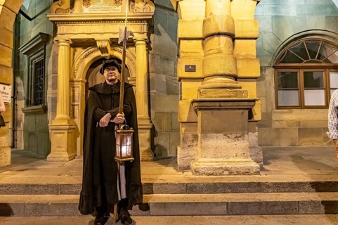 The night watchman in front of the town hall at dusk, Rothenburg ob der Tauber at dusk, Bavaria,