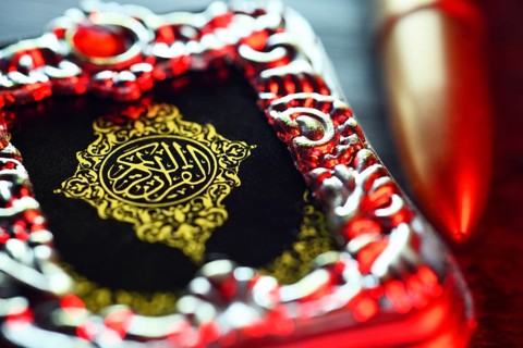 Koran and rifle cartridge, symbolic photo Islamism