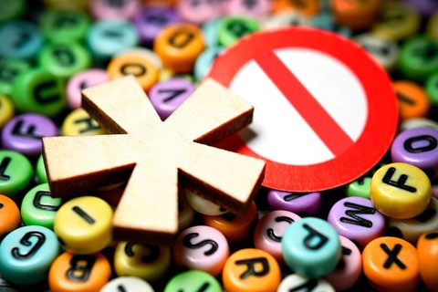 Gender star and prohibition sign on letters