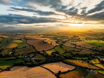 Sunset of Fields and Farms over Devon from a drone, Torquay, Torbay, Devon, England, United Kingdom