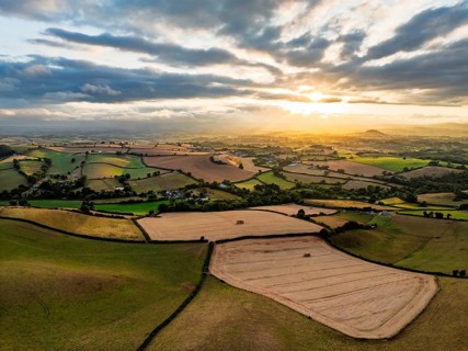 Sunset of Fields and Farms over Devon from a drone, Torquay, Torbay, Devon, England, United Kingdom