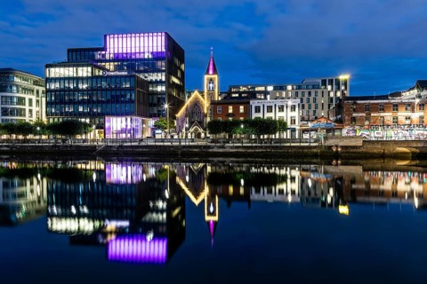 Office building and church reflected in the River Liffey, blue hour, Dublin, Ireland