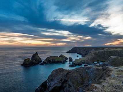 Sunset over Kynance Cove from a drone, Mount's Bay, Lizard Point, Cornwall, England, United Kingdom