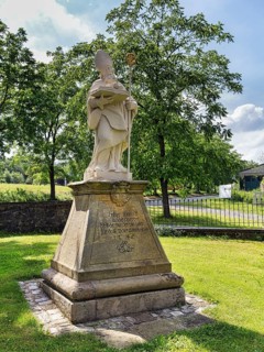 Saint Liborius, stone statue on a pedestal with inscription, parish church of St Maximilian,