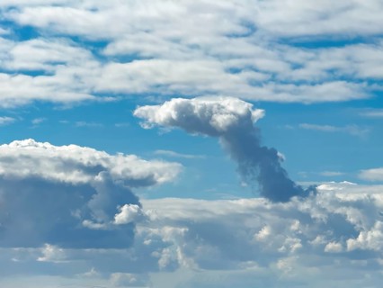 Cumulonimbus cluster cloud towering in the centre of the image, Altostratus above, Stratocumuus