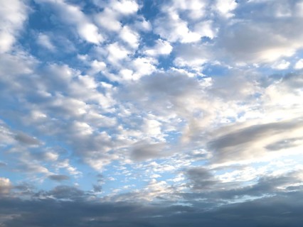 View at dusk on top large cloud field of cirrocumulus clouds drifting at high altitude white