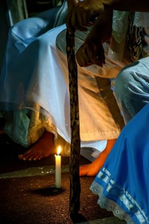 Moment of prayer illuminated by candles in a religious ceremony of Umbanda, Belo Horizonte, Minas