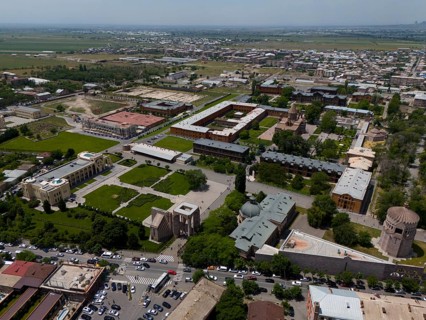 Urban landscape with buildings and green areas from a bird's eye view. Sunny atmosphere, aerial