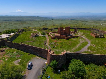 View of a lonely ancient fortress in a vast landscape with a distant mountain, Dashtadem Fortress,