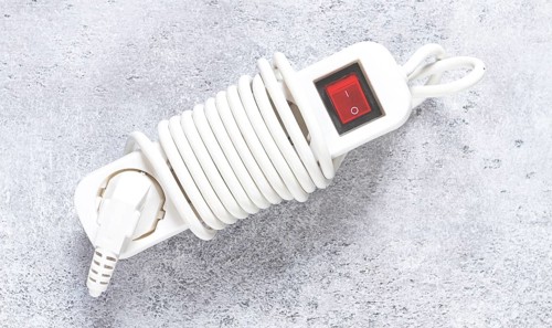 Power cord with switch and coiled design for easy storage in household or office settings