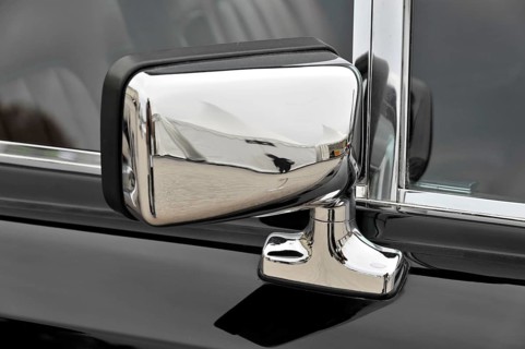 Chrome-plated side mirror of a classic car reflects the surroundings, Retro Classics meets Baroque,