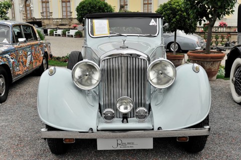 Bentley 4 ¼ Ltr. classic car, light grey convertible with open top in front of a historic building,