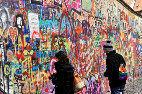 John Lennon Wall, Graffiti, Prague, Czech Republic, Europe, Two people look at a colourful wall