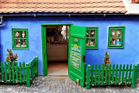 Prague, Czech Republic, Europe, Small blue house with green fence and decorative details in bright