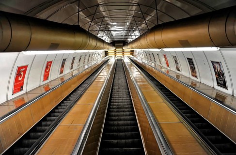 Long escalators in a modern underground station with futuristic lighting, Prague, Czech Republic