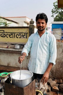 Kota, Rajasthan, North India, Asia, A vendor boiling milk in a pot on the street in a rural area,