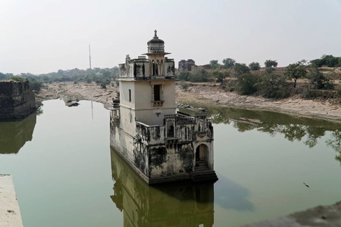Kota, Rajasthan, North India, Asia, Historic tower in the middle of a lake with reflecting water