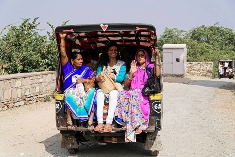 Kota, Rajasthan, North India, Asia, Women in traditional dress sit happily in the back of an