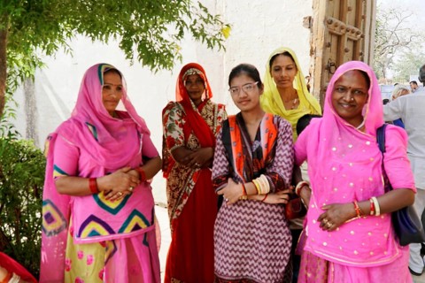 Kota, Rajasthan, North India, Asia, Group of woman in traditional dress standing under a tree,