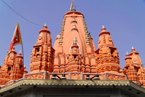 Kota, Rajasthan, North India, Asia, Bright red temple tower with Hindu architecture in the blue