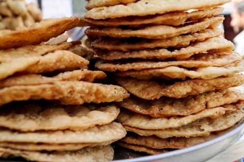 Kota, Rajasthan, North India, Asia, Side view of fried flatbreads stacked on a tray, India