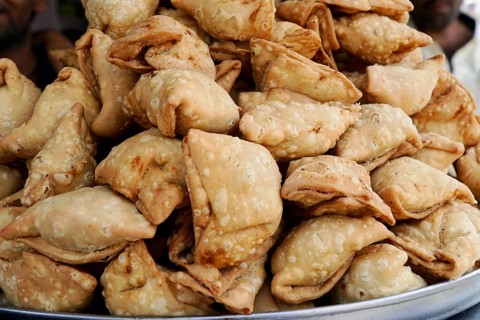 Kota, Rajasthan, North India, Asia, Stack of deep-fried samosas on a tray at the market, India