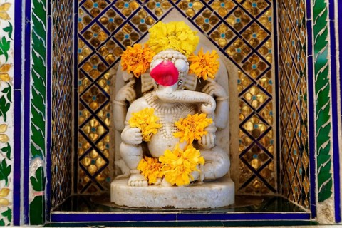 City Palace, Udaipur, Rajasthan, India, Asia, Marble statuette of Ganesha, adorned with flowers, in
