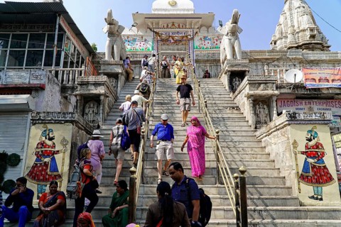 Entrance to Jagdish Temple, Udaipur, People climbing the steps to a temple flanked by statues under