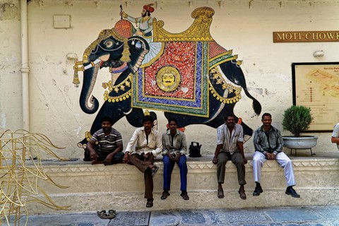 Udaipur, Rajasthan, North India, Asia, Several men sitting in front of an artistically painted