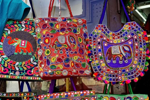 Udaipur, Rajasthan, North India, Asia, Different coloured embroidered bags with elephant patterns