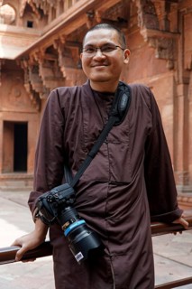 Red Fort, Agra, Uttar Pradesh, India, Smiling man with camera in front of decorated historical