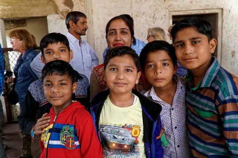 Red Fort, Agra, Uttar Pradesh, India, Group of children smiling friendly in a simple interior with