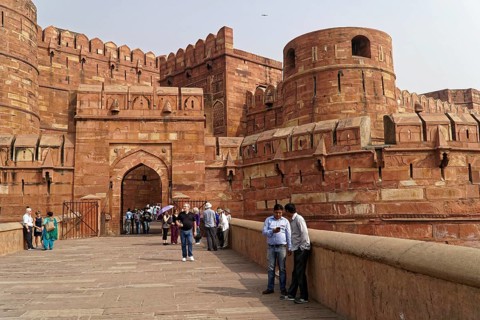 Red Fort, Agra, Uttar Pradesh, India, Visitors standing on a pavement in front of a historic fort,