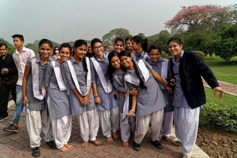 A group of students in uniforms posing happily in a park, Agra, Jodhpur, Rajasthan, North India