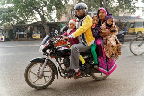Agra, Jodhpur, Rajasthan, North India, Asia, family with three children on a motorbike on a busy