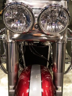 Close-up view of round chrome headlights of a motorbike with red elements, dortmund, deutchland