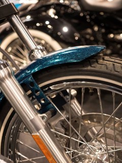 Close-up of a motorbike tyre with wire spokes and chrome rim, Dortmund, Germany