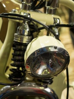 Vintage-style headlight on a cream-coloured motorbike with chrome details, dortmund, deutchland