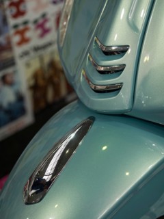 Close-up of a blue vintage-style scooter with chrome trim and shiny paintwork, dortmund, deutchland