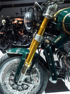 Detailed view of a motorbike with gold-coloured suspension and green fairing, dortmund, deutchland